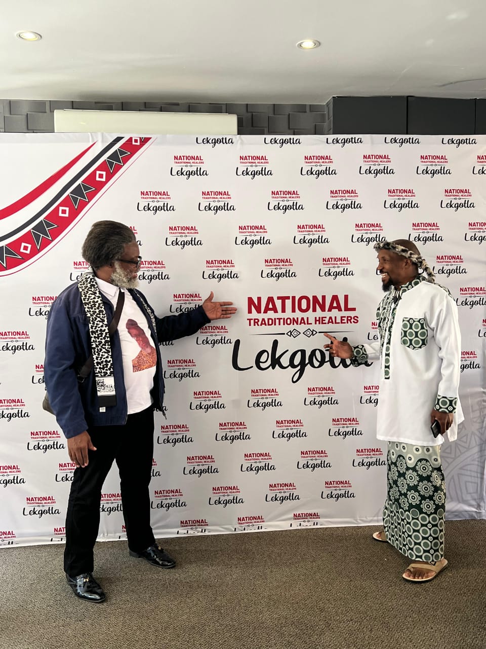 Two Traditional Health Practitioners standing in front of the National Traditional Healers Lekgotla 2026 banner during the inaugural gathering of Abelaphi Bendabuko in South Africa.